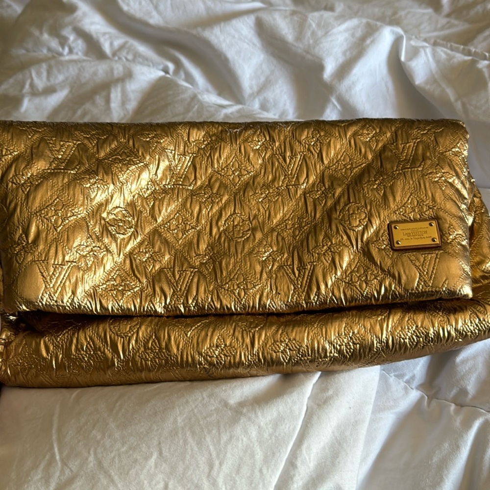 Louis Vuitton gold metallic clutch. I wore it maybe three times.